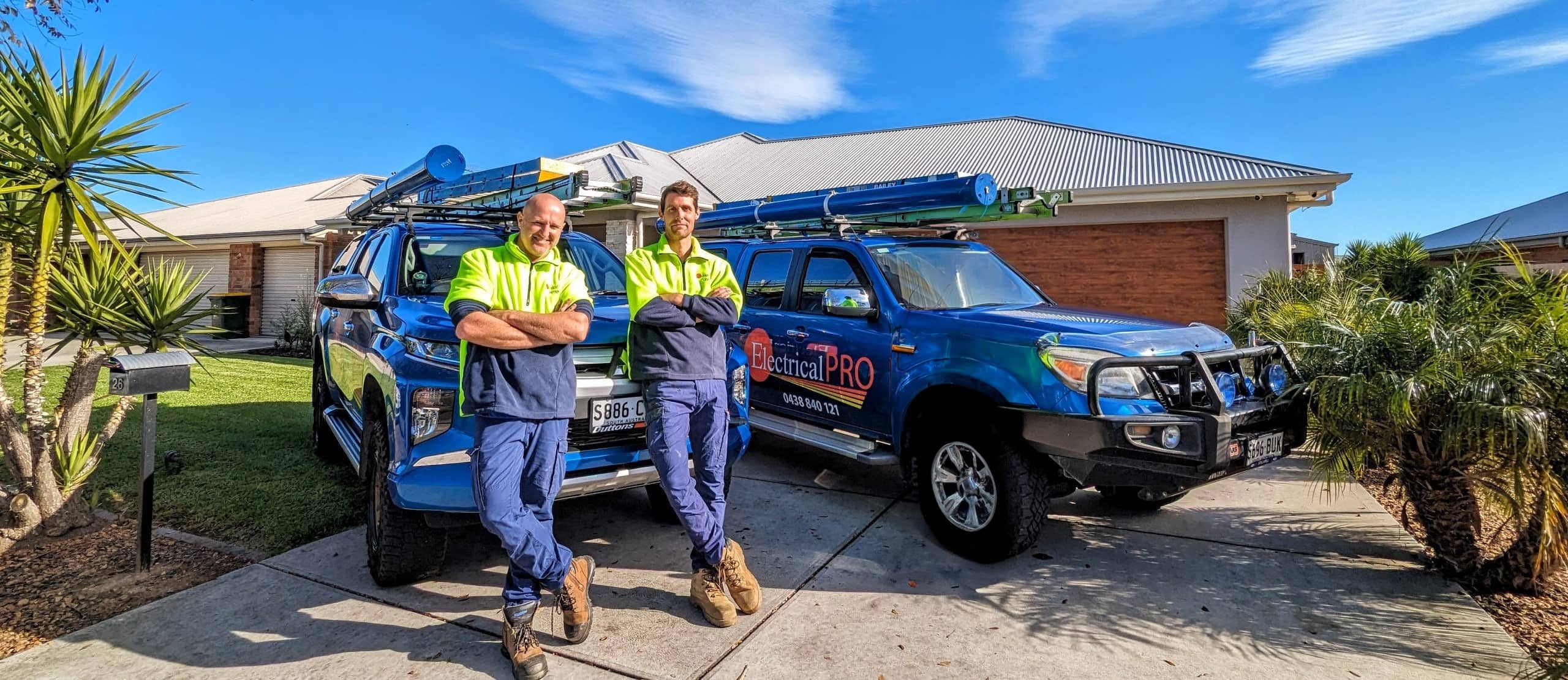 ElectricalPro team with branded work vehicles