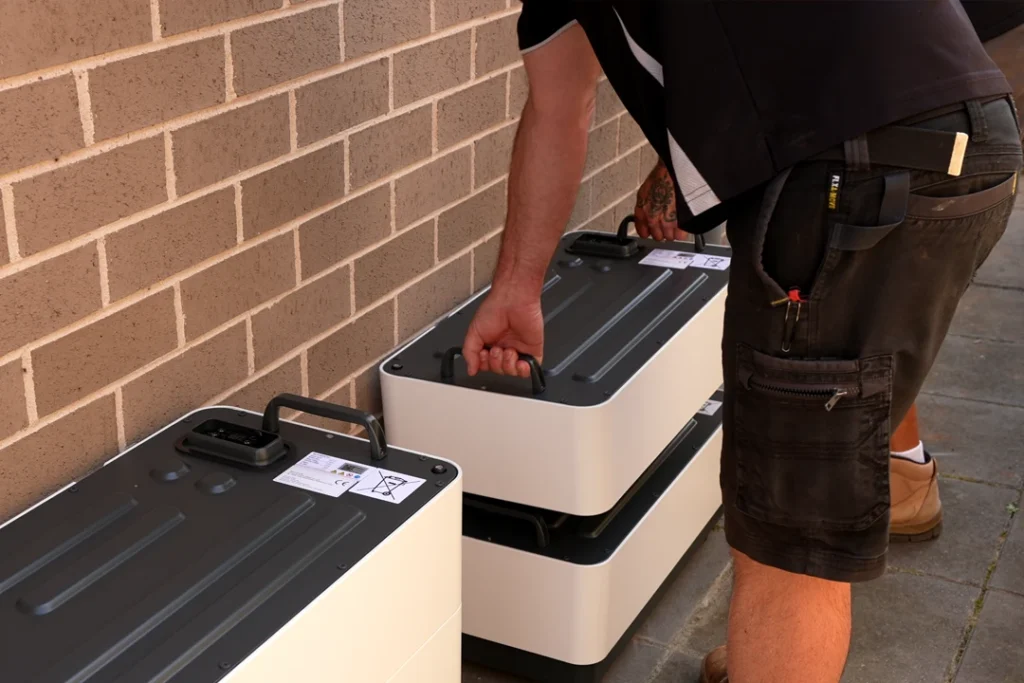 Sungrow battery modules being stacked during an ElectricalPro retrofit